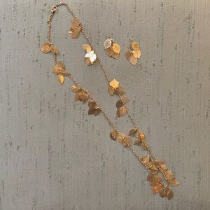 Gold tone leaf long necklace and earrings set.